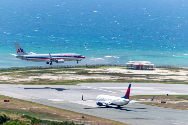 American Airlines landing while Delta waits to depart from Montego Bay